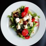 Delicious Greek salad featuring fresh vegetables and creamy feta cheese, perfect for a healthy meal.